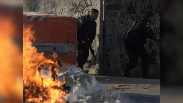 Violence between army-backed police and criminal gangs in Rio de Janeiro kills seven including 14-year-old boy