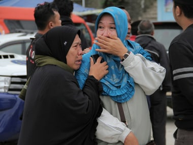 Relatives mourn the demise of their loved ones after the ferry disaster in Simalungun. AP
