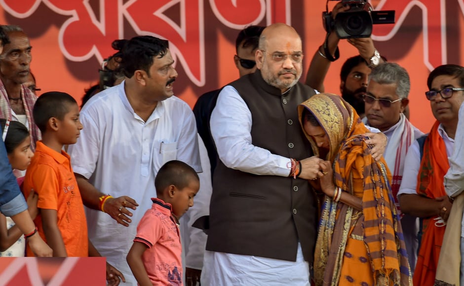 BJP national president Amit Shah meets a member of Shahid family during a public rally, in Purulia district of West Bengal on Thursday. Shah drew the battle lines at a rally in West Bengal's Purulia on Thursday as he sounded the poll bugle ahead of the 2019 Lok Sabha polls. In a scathing attack on Mamata Banerjee, Shah said that the West Bengal chief minister BJP national president Amit Shah meets a member of Shahid family during a public rally, in Purulia district of West Bengal on Thursday. Shah drew the battle lines at a rally in West Bengal's Purulia on Thursday as he sounded the poll bugle ahead of the 2019 Lok Sabha polls. In a scathing attack on Mamata Banerjee, Shah said that the West Bengal chief minister