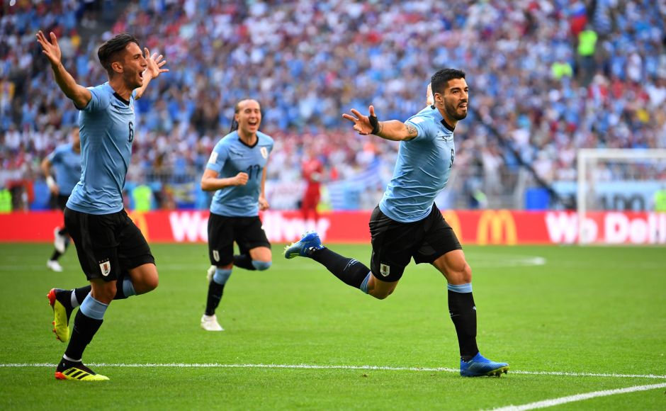 Uruguay's Luis Suarez celebrates scoring their first goal. Uruguay recorded a 3-0 victory over 10-man Russia, finishing top of Group A with a perfect record while dampening the hopes of the tournament hosts, who had to settle for second. Reuters Uruguay's Luis Suarez celebrates scoring their first goal. Uruguay recorded a 3-0 victory over 10-man Russia, finishing top of Group A with a perfect record while dampening the hopes of the tournament hosts, who had to settle for second. Reuters