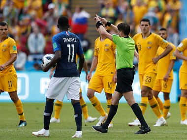 Referee Andres Cunha from Uruguay gestures for a penalty fro France after consulting VAR, from which France's Antoine Griezmann scored, during the group C match. AP