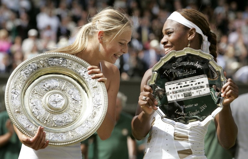 File photo of Maria Sharapova and Serena Williams holding their respective trophies after their women's final match at Wimbledon in 2004. Seventeen-year-old Sharapova won the match, 6-1, 6-4. Reuters