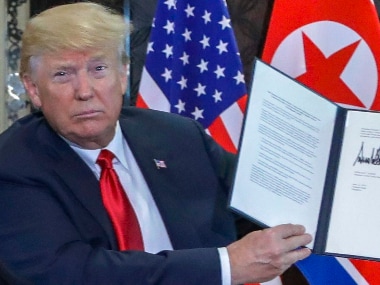 US President Donald Trump holds the signed document in front of the media post his meeting with North Korean leader Kim Jong-un in Singapore on Tuesday.