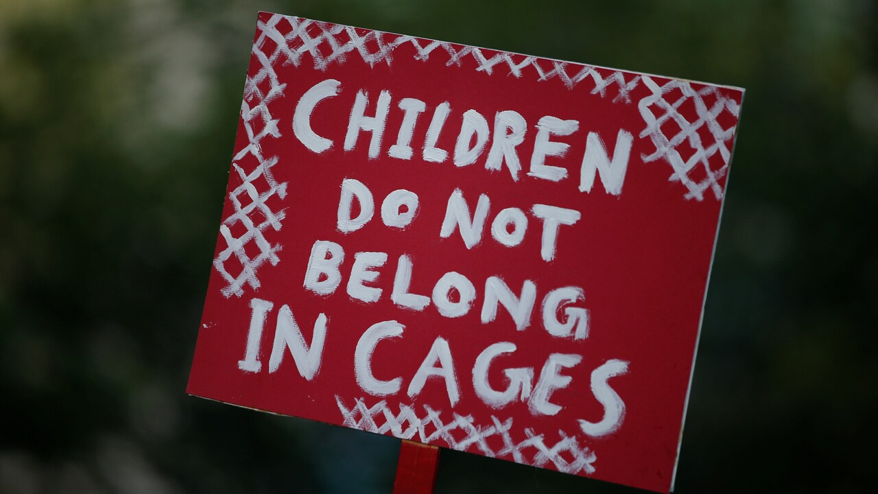 A sign is raised as people protest against the Trump administration policy of separating immigrant families suspected of illegal entry, in New York. Reuters.