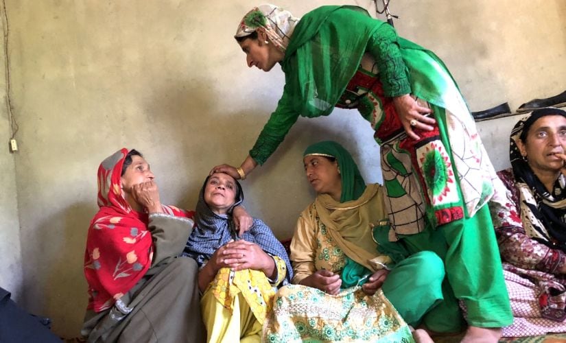 Azi Begam, mother of Ghulam Hassan Chopan, is being consoled by relatives. Image courtesy: Sameer Yasir