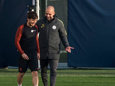 Manchester City's Spanish football coach Pep Guardiola (R) speaks with David Silva during a team training session at the City Football Academy in Manchester, northern England on October 31, 2016. / AFP PHOTO / OLI SCARFF