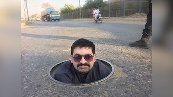 Pakistan General Election goes 'down the drain' as Karachi politician lies in a puddle of sewage to ask for votes