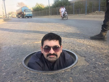 Pakistan General Election goes 'down the drain' as Karachi politician lies in a puddle of sewage to ask for votes Pakistan General Election goes 'down the drain' as Karachi politician lies in a puddle of sewage to ask for votes