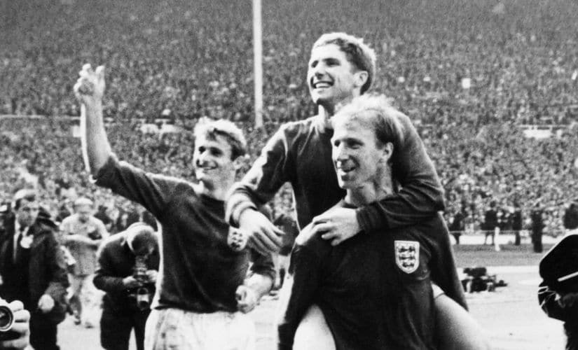 English defender Jackie Charlton carries his teammate midfielder Alan Ball, with forward Roger Hunt smiling behind, as they celebrate their team's victory over West Germany in the final of the World Cup on July 30, 1966 at Wembley Stadium in London. Forward Geoff Hurst scored three times, twice in the extra-time, as England beat West Germany 4-2 in overtime (2-2 at the end of regulation time) to win the World Cup title. AFP