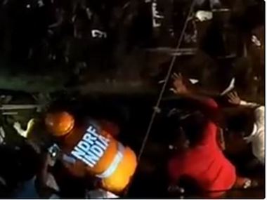 Portion of three-storey building collapses in Thane's Bhiwandi; three people rescued, five feared trapped Portion of three-storey building collapses in Thane's Bhiwandi; three people rescued, five feared trapped