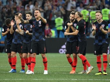   Croatian players react during the penalty shootout against Denmark. AFP 