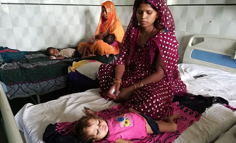 Gudiya, 24, sits by her 18-month-old daughter Mahi at the nutrition rehabilitation centre in Chitrakoot.