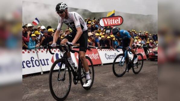 Tour de France: Chris Froome's race almost ends as policeman knocks him off bike after mistaking him for fan