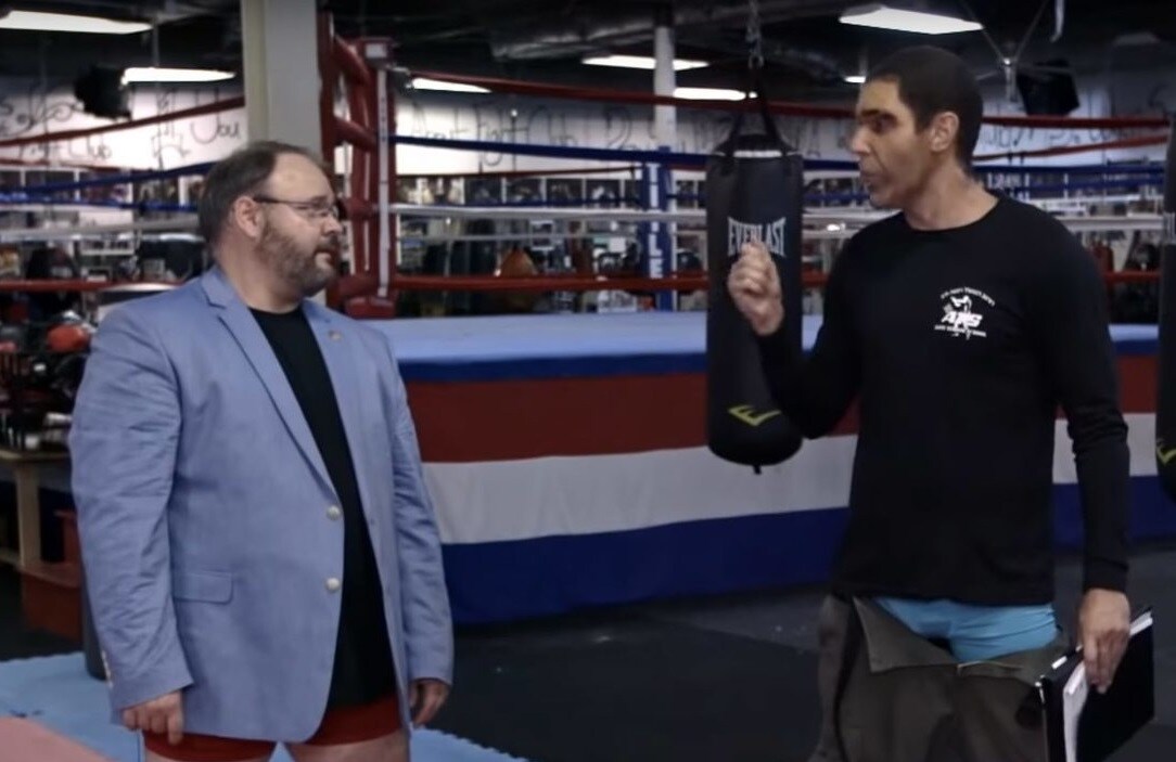 Republican Rep. Jason Spencer (L) and Sacha Baron Cohen as Erran Morad. Image via Twitter