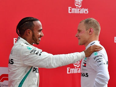 Winner Mercedes' British driver Lewis Hamilton (L) talks with second placed Mercedes' Finnish driver Valtteri Bottas after the German Formula One Grand Prix at the Hockenheim racing circuit on July 22, 2018 in Hockenheim, southern Germany. / AFP PHOTO / Andrej ISAKOVIC