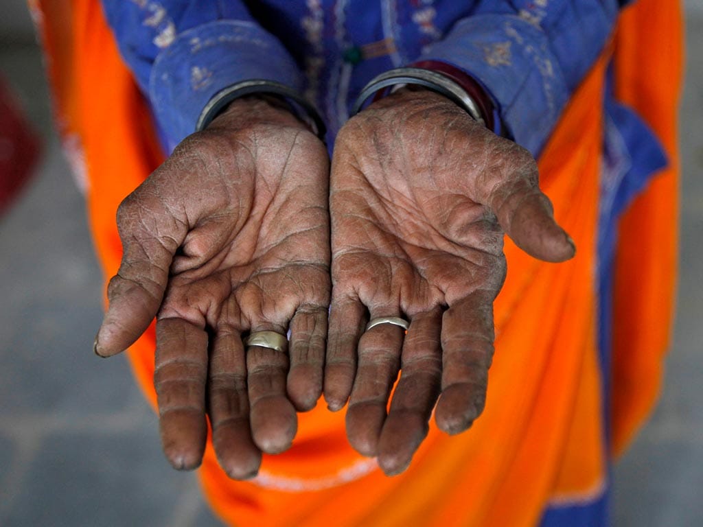Radha, 75, a vegetable vendor poses with her hands after she got her fingerprint scanned for the Unique Identification (UID) database system. Reuters