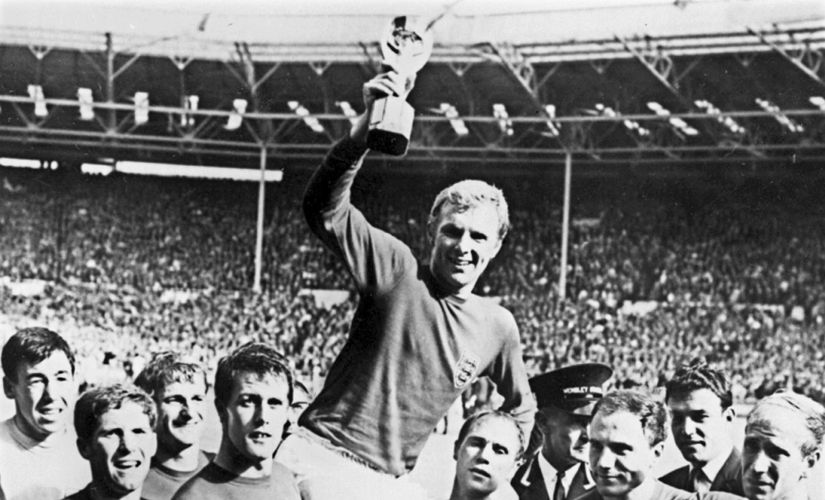 England's Bobby Moore holds aloft the Jules Rimet trophy as he is carried by his teammates after the 1966 World Cup final. AFP