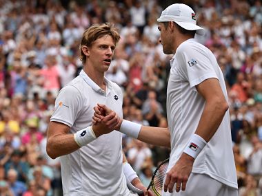 South Africa's Kevin Anderson (L) shakes hands after winning against US player John Isner during the final set tie-break of their men's singles semi-final match on the eleventh day of the 2018 Wimbledon Championships at The All England Lawn Tennis Club in Wimbledon, southwest London, on July 13, 2018. Anderson won the match 7-6, 6-7, 6-7, 6-4, 26-24. / AFP PHOTO / POOL / Glyn KIRK / RESTRICTED TO EDITORIAL USE