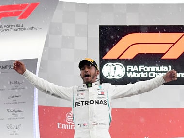 Mercedes driver Lewis Hamilton of Britain celebrates on the podium after winning the German Formula One Grand Prix at the Hockenheimring racetrack in Hockenheim, Germany, Sunday, July 22, 2018. (AP Photo/Jens Meyer)