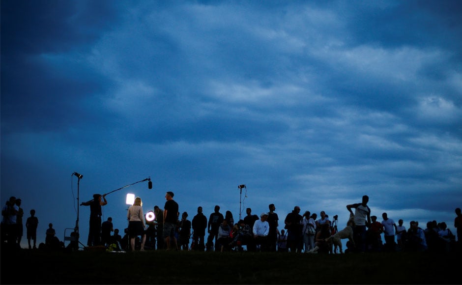 People gather on Hampstead Heath to observer the lunar eclipse, in London. Unlike with a solar eclipse, viewers did not need protective eye gear to observe the rare display. Reuters People gather on Hampstead Heath to observer the lunar eclipse, in London. Unlike with a solar eclipse, viewers did not need protective eye gear to observe the rare display. Reuters