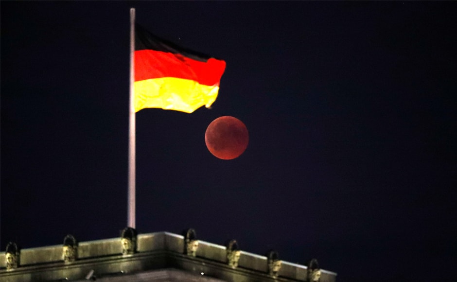 The moon seen during the lunar eclipse next to the German national flag on top of the Reichstag building in Berlin. For about half the world, the moon was partly or fully in Earth's shadow from 1714 to 2328 GMT - six hours and 14 minutes in all. Reuters The moon seen during the lunar eclipse next to the German national flag on top of the Reichstag building in Berlin. For about half the world, the moon was partly or fully in Earth's shadow from 1714 to 2328 GMT - six hours and 14 minutes in all. Reuters