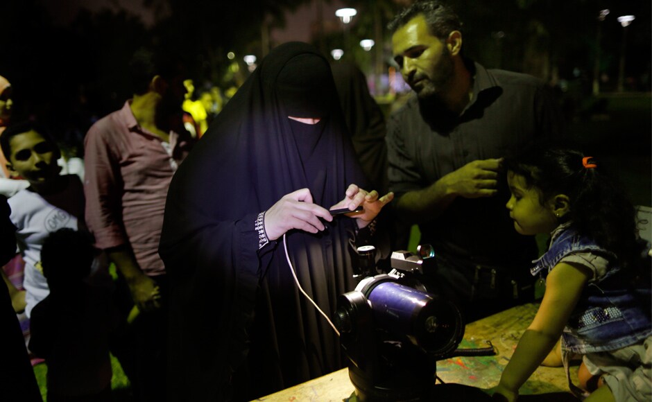 People take pictures for the lunar eclipse through a telescope at the Children's Civilization and Creativity Center in Cairo. AP People take pictures for the lunar eclipse through a telescope at the Children's Civilization and Creativity Center in Cairo. AP