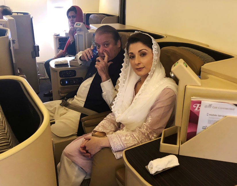 Ousted Pakistani Prime Minister Nawaz Sharif and his daughter Maryam sit on a Lahore-bound flight due for departure, at Abu Dhabi International Airport. Reuters