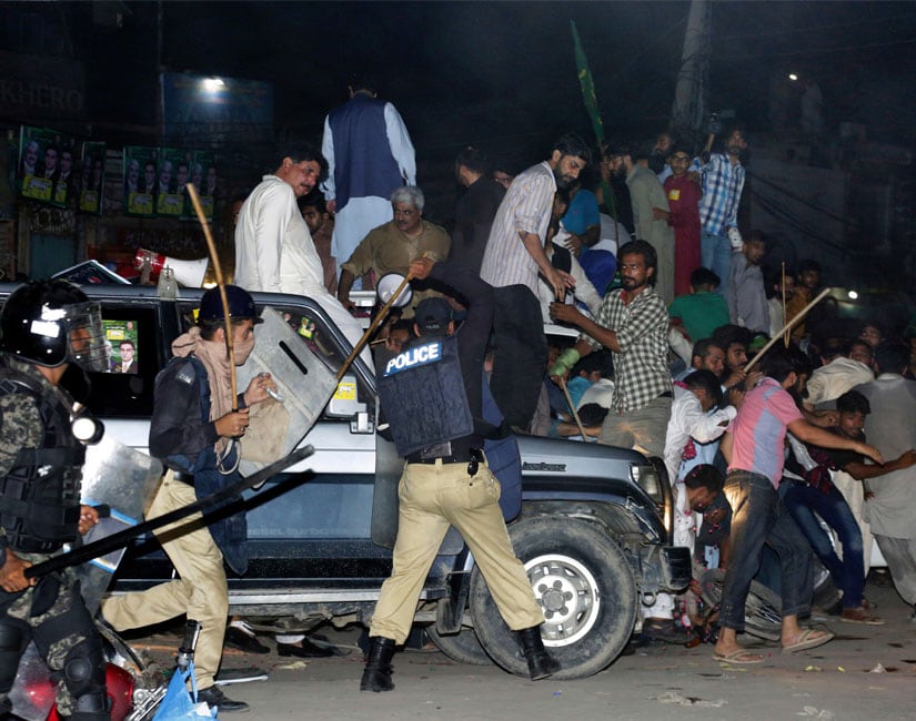 Police use force to disperse supporters of former prime minister Nawaz Sharif who gathered to see him in Lahore. AP