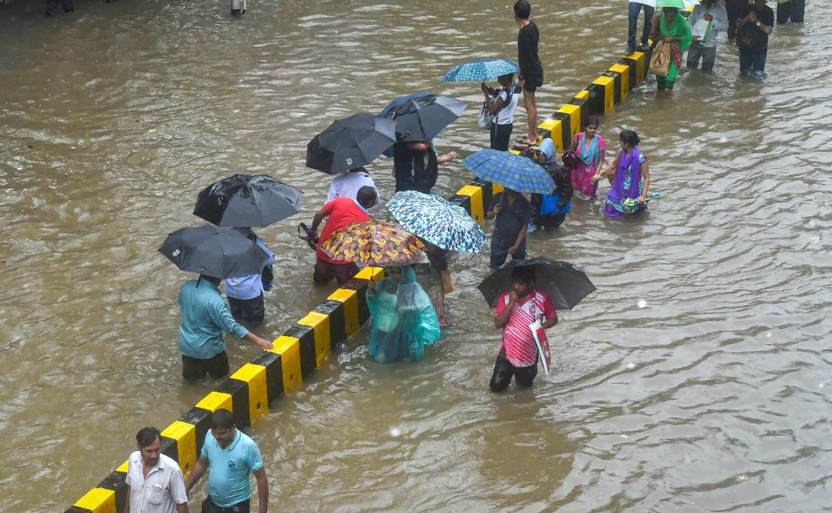 The downpour flooded many roads and streets in low-lying areas of the city and its adjoining districts of Palghar and Thane. People at some places were seen wading through waist-deep water. PTI The downpour flooded many roads and streets in low-lying areas of the city and its adjoining districts of Palghar and Thane. People at some places were seen wading through waist-deep water. PTI