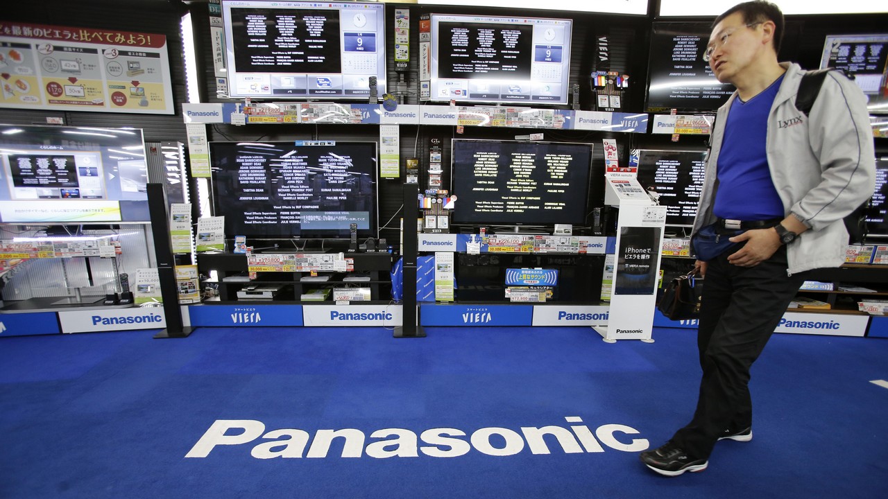A man walks past Panasonic Corp's Viera televisions displayed at an electronics store in Tokyo May 9, 2013. Panasonic Corp forecast its operating profit will more than triple in the year to March 31 as it steps back from struggling operations in TVs and other consumer gadgets in favour of selling machinery, components and electronic equipment to other businesses. Picture taken May 9, 2013. REUTERS/Toru Hanai (JAPAN - Tags: BUSINESS) - GM1E95A15Y901