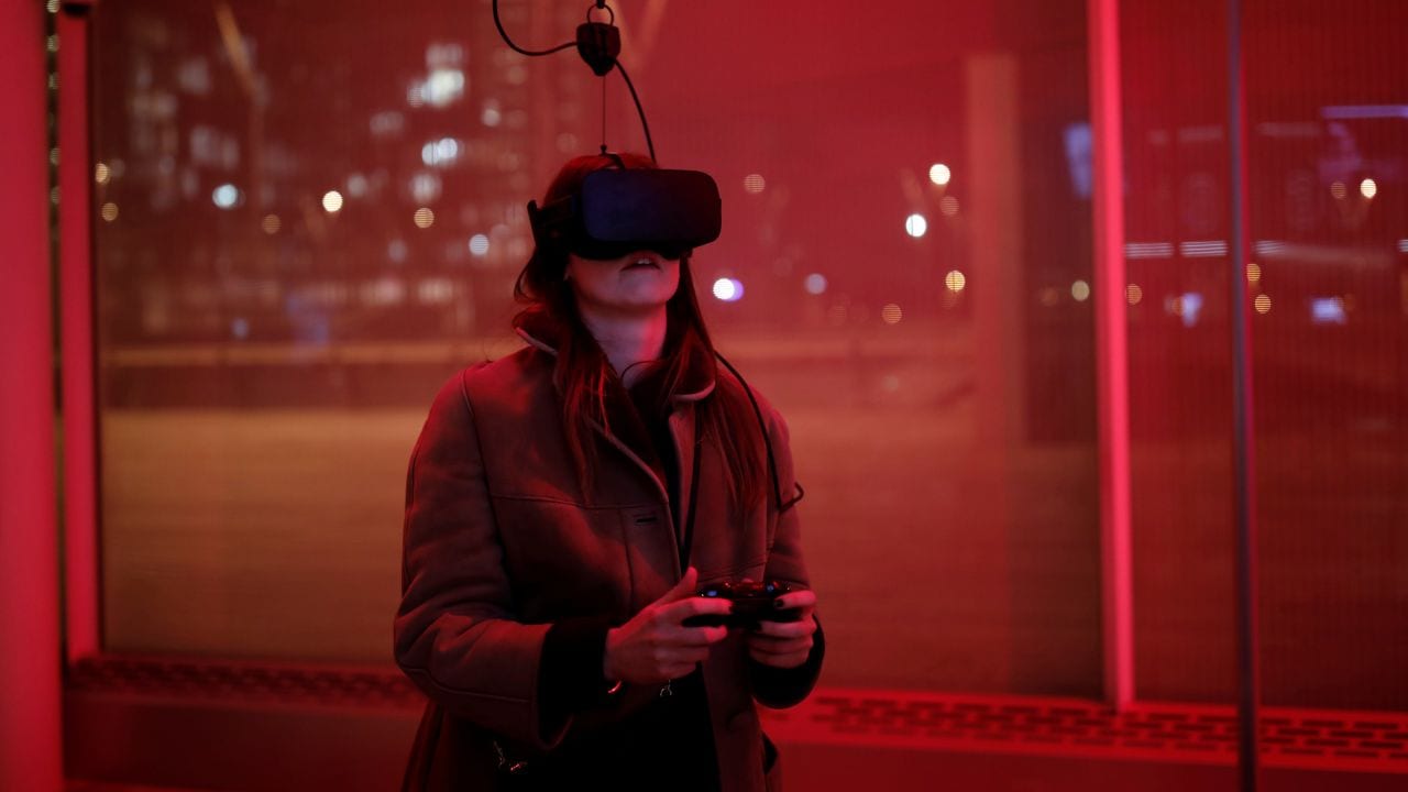 A woman plays a video game with the Oculus Rift VR headset at the mk2 VR, a place dedicated to virtual reality in Paris