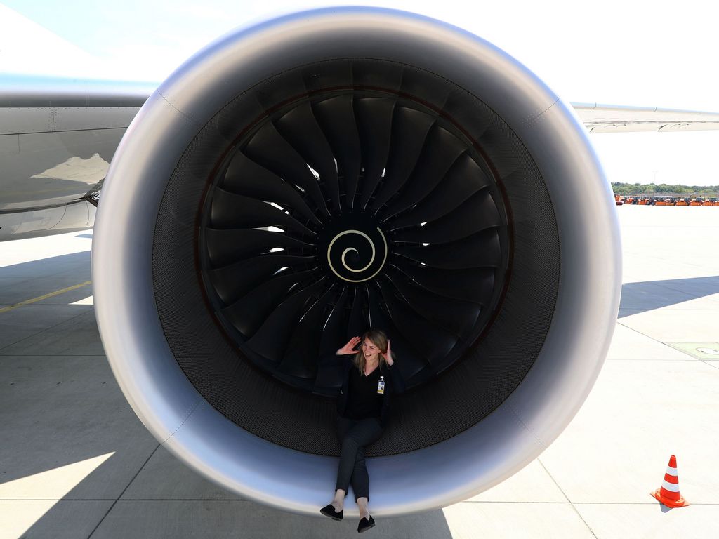 PR agent Elsa Goette sits in a Rolls-Royce engine of an Airbus A350-900 of Ethiopian Airlines during a site-inspection at Fraport airport in Frankfurt, Germany, May 22, 2017. REUTERS/Kai Pfaffenbach - RC1965B9C170