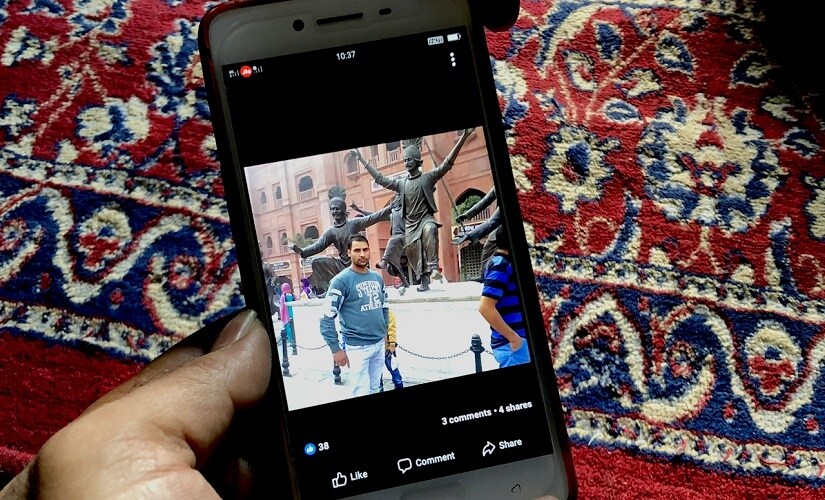 Mohammad Saleem Shah's brother showing a picture of the cop taken a few months ago. Firstpost/Sameer Yasir