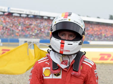 Ferrari driver Sebastian Vettel of Germany walks back to his pits after he crashed into the track wall during the German Formula One Grand Prix at the Hockenheimring racetrack in Hockenheim, Germany, Sunday, July 22, 2018. (AP Photo/Jens Meyer)