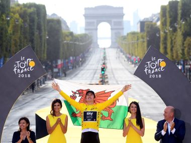   The Team Sky rider Geraint Thomas celebrates his victory on the podium. Reuters 