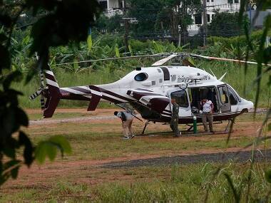 A helicopter waits near the cave for more evacuations of the boys and their soccer coach. AP