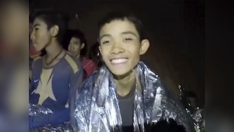 Thai boys trapped in cave smile, joke with rescuer; heavy rains forecast threatens to complicate extraction