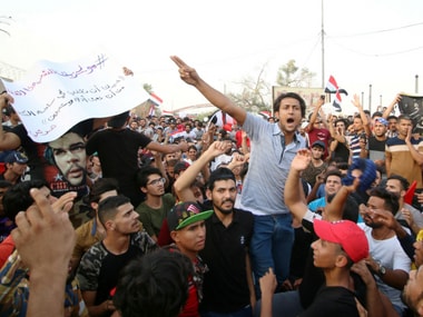 People shout slogans during a protest near the main provincial government building in Basra. Reuters