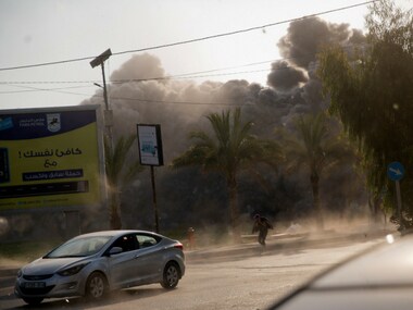 Smoke raises in the background following an Israeli airstrike hits a governmental building in Gaza City. AP 