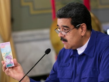 Venezuela's President Nicolas Maduro holds a bank note of the new Venezuela's currency Bolivar Soberano. Reuters