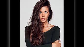 Model Mara Martin breastfeeds her baby while walking the runway