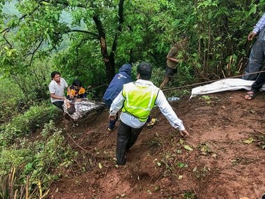 Mahabaleshwar Trackers members take out bodies at the accident site where a bus carrying a group of staff members of an agriculture university, fell into a 500-ft gorge in the Konkan region, killing 33 passengers, in Raigad on Saturday. PTI
