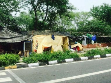 Makeshift homes inhabited by urban farmers along the footpath on a bridge over the Yamuna in East Delhi.