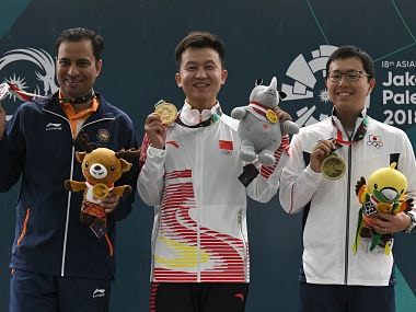 From L to R: Silver medallist India's Sanjeev Rajput, gold medallist China's Hui Zicheng, and bronze medallist Japan's Takayuki Matsumoto pose with their medals during their victory ceremony for the men 50m rifle 3 positions shooting final during the 2018 Asian Games in Palembang on August 21, 2018. / AFP PHOTO / Mohd RASFAN
