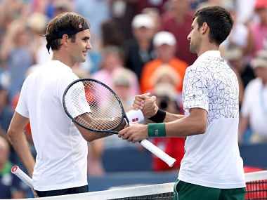 (FILES) In this file photo taken on August 18, 2018 Roger Federer of Switzerland congratulates Novak Djokovic of Serbia after their match during the men's final of the Western & Southern Open at Lindner Family Tennis Center in Mason, Ohio. Five-time champion Roger Federer could find himself up against Novak Djokovic in the quarter-finals of the US Open, where Serena and Venus Williams could meet in a third-round blockbuster. Federer, the second seed, opens against Japan's Yoshihito Nishioka, anchoring a bottom quarter of the men's singles draw announced August 23, 2018 that also features sixth-seeded Djokovic, the reigning Wimbledon champion who bested the Swiss great in the final at the Cincinnati Masters last week. / AFP PHOTO / GETTY IMAGES NORTH AMERICA / MATTHEW STOCKMAN