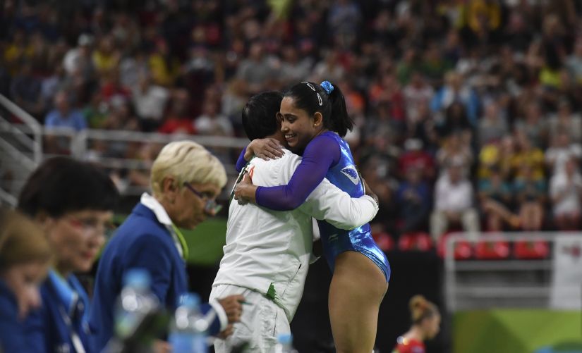 Dipa Karmakar embraces coach Bishweshwar Nandi after performing Produnova vault at Rio Olympics. AFP