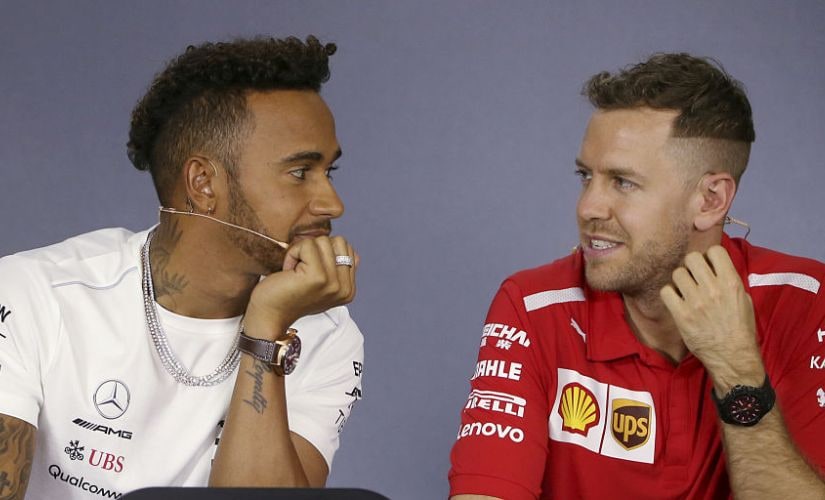 Mercedes driver Lewis Hamilton of Britain and Ferrari driver Sebastian Vettel of Germany, right, look at each other during a drivers' press conference at the Australian Formula One Grand Prix in Melbourne, Thursday, March 22, 2018. The first race of the 2018 seasons is on Sunday. (AP Photo/Rick Rycroft)