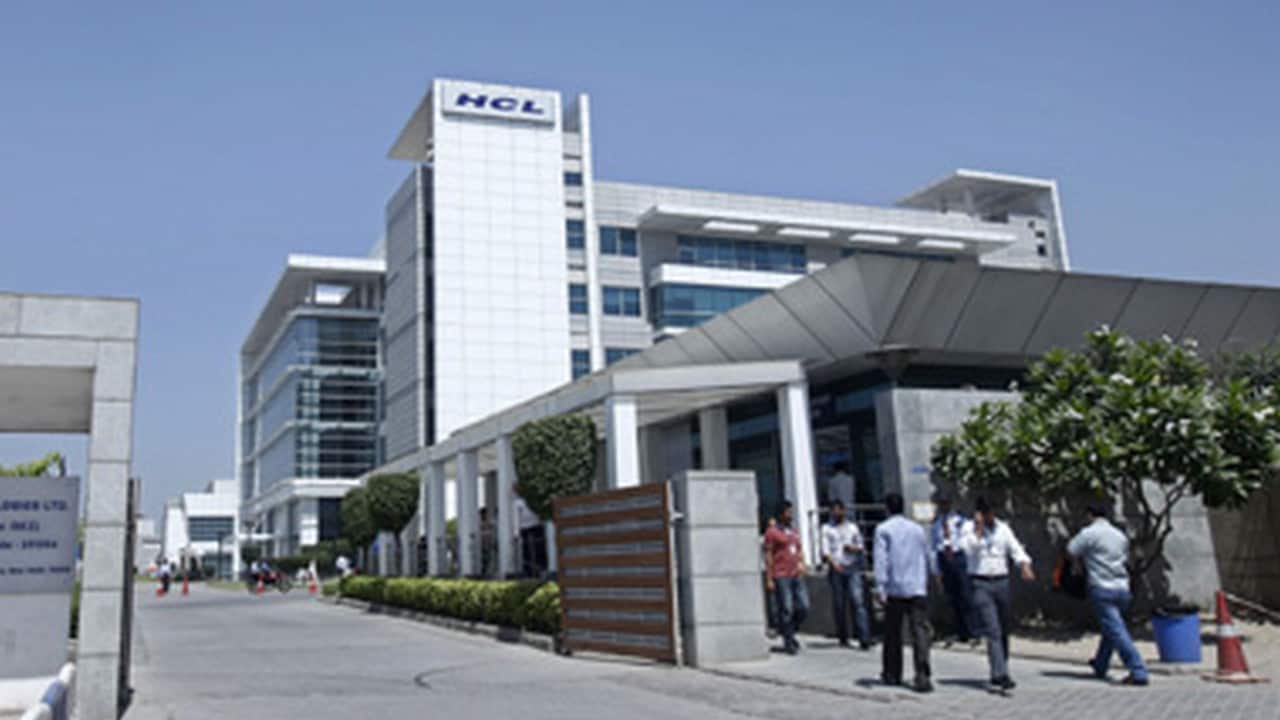 People walk in front of the HCL Technologies Ltd office at Noida. Reuters