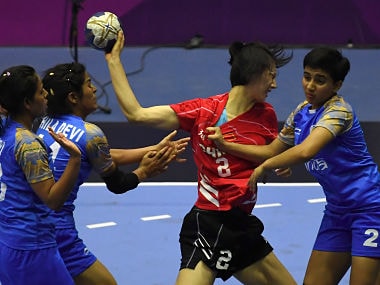 Lin Yanqun of China attempts a shot on goal as India's Nidhi Sharma defends during the women's handball preliminary Group A match between India and China at the 2018 Asian Games in Jakarta. AFP