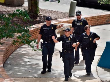 Police investigate the scene of a multiple shooting at The Jacksonville Landing on Sunday. AP